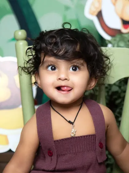 A playful moment in the jungle! This close-up captures a cheeky expression during a 'Wild One' themed first birthday shoot.