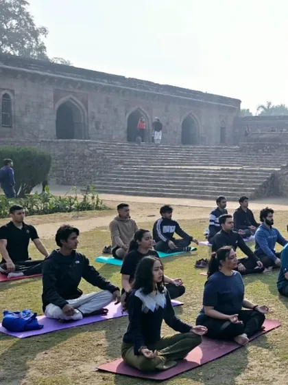 A group of dedicated individuals meditating together outdoors. The collective focus and shared intention create a powerful sense of peace and connection.