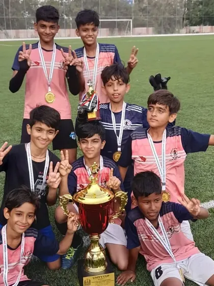 Champions. Our team celebrates lifting the Unity Football Tournament trophy. These victories are a testament to the hard work and unity of our players and coaches.