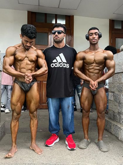 A final check-in with two of my competitors. We ensure every detail is perfect, from the tan to the posing, before they compete.