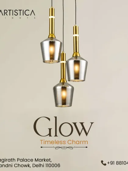 A beautiful cluster of three bell-shaped pendants with smoked glass and gold accents. This arrangement provides a timeless charm and a warm, layered light effect, perfect for hanging over a small table or in an entryway.