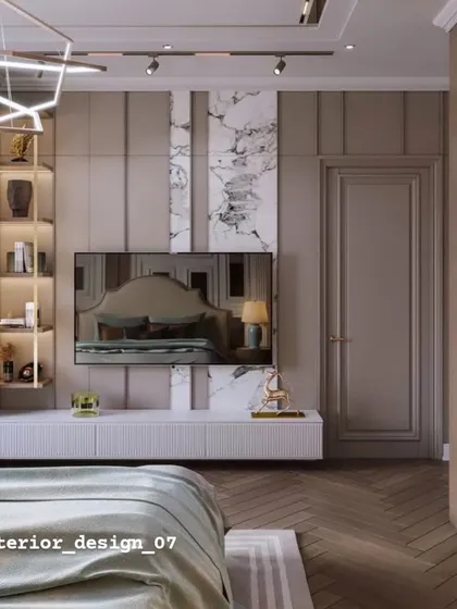 An elegant TV wall in a bedroom, combining vertical wood paneling with a marble accent. The floating white console and illuminated display shelf add to the sophisticated feel.