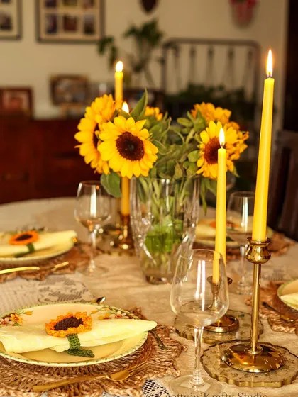 A festive table set for making memories. Here, my handmade sunflower napkin ties add a touch of sunshine to each place setting. I believe that gatherings are made special by these small, thoughtful details that bring warmth and personality to the table.