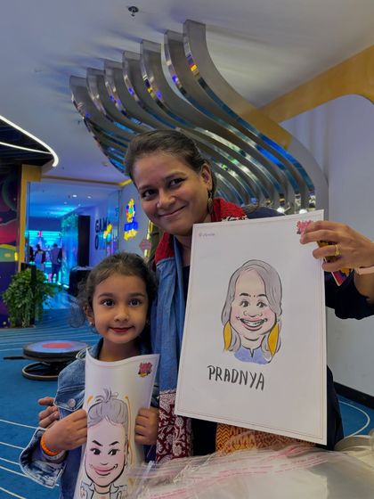 A mother and daughter duo with their matching caricatures. It's a lovely way to create a shared memory at a family function.