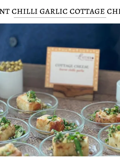 My Burnt Chilli Garlic Cottage Cheese is a fusion of smoky and spicy flavors. Here it is served in individual glass bowls, garnished with fresh herbs.