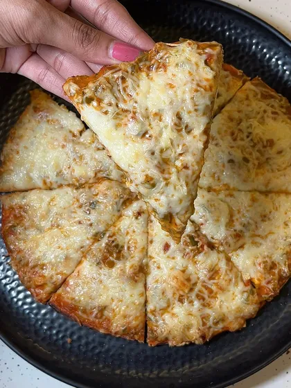 Taking a slice of my Melting Cheese Pizza. It's a simple pleasure that's hard to resist.