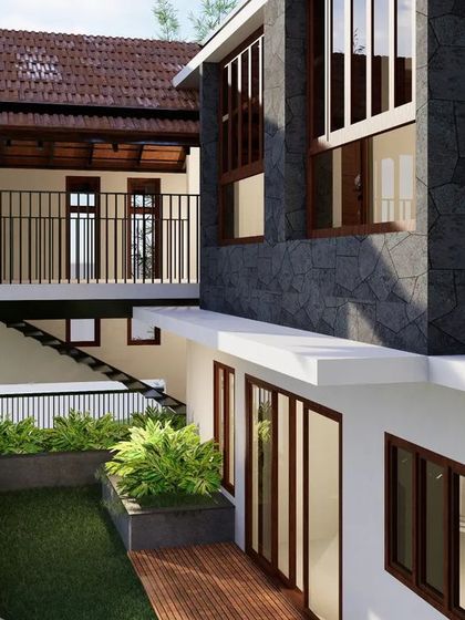 Sloping roofs were strategically incorporated to harmonize with Coorg's climatic conditions. This view highlights the interplay between the built form and a sunken garden court, with ample openings allowing natural light to filter into the interior spaces.