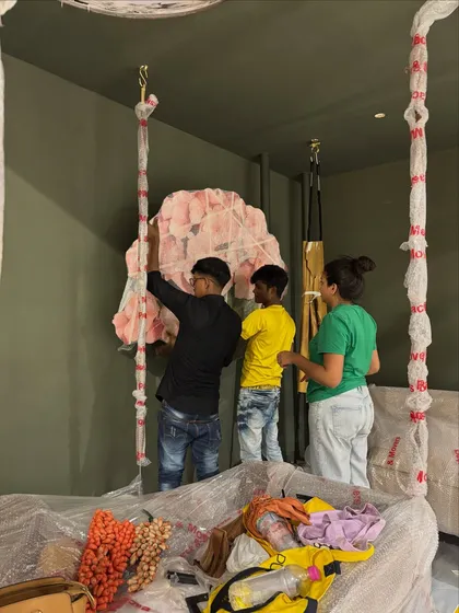 My team and I installing a large, mixed-media floral art piece. Collaboration is key to bringing these complex installations to life.