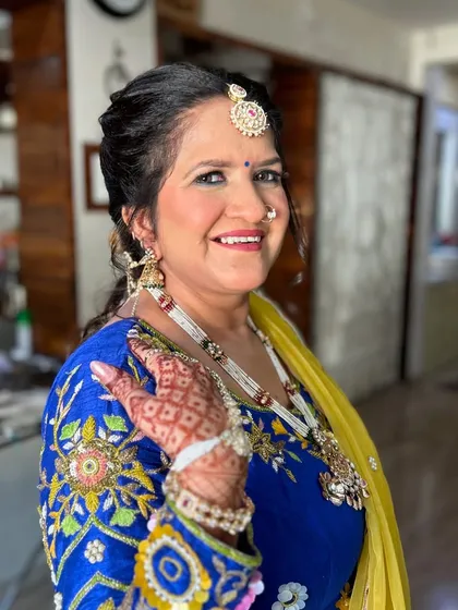 A radiant and happy client, ready for a wedding. Her makeup is fresh and glowing, and her smile says it all.