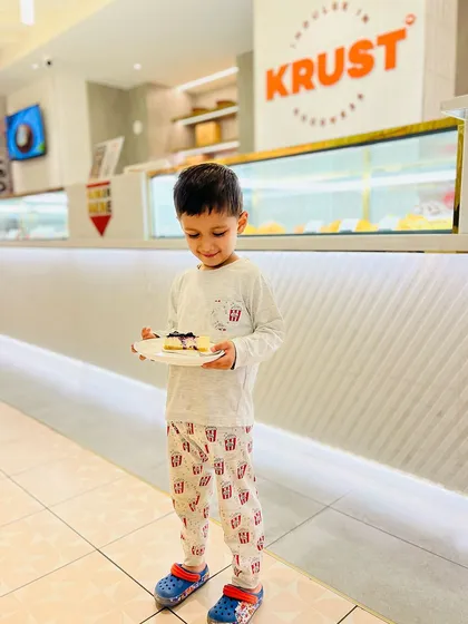 A young guest enjoying a slice of our cheesecake right here in the café. Seeing these happy moments is the best part of my job.