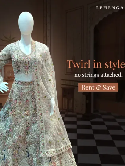 A full view of a stunning floral embroidered lehenga on a mannequin. The intricate, multi-colored threadwork on the light base makes this a sophisticated choice for any wedding event.