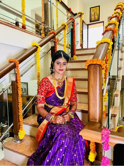 The bride looks so serene and beautiful in this shot. The makeup is soft and enhances her features, perfect for the occasion.