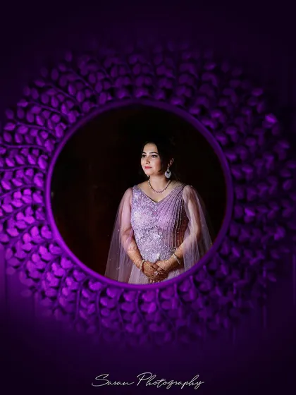 A creative portrait of the bride-to-be, framed by a decorative purple mirror at her engagement ceremony.