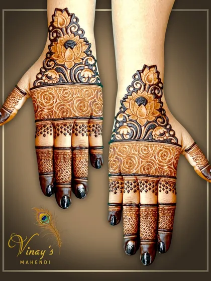 A simple yet stunning design focusing on a bold lotus cuff at the wrist, with detailed rose patterns on the palm.