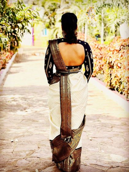 A duplicate image showing the back of a client in a Kanjeevaram saree and custom blouse.