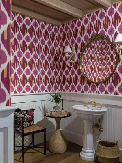 I love breaking design rules, like using bold wallpaper in a small powder room. This vibrant ikat-patterned wallpaper in a Saratoga home turns a small space into a jewel box, making a powerful design statement.