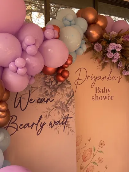 A close-up of the custom backdrop for the "Bearly Wait" theme, showing the elegant script and floral details.