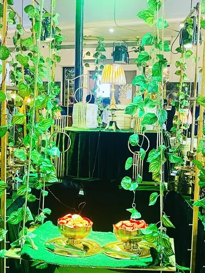 Another angle of the lush green and gold buffet design. The combination of natural elements and metallic finishes provides a rich and luxurious feel for any corporate event.