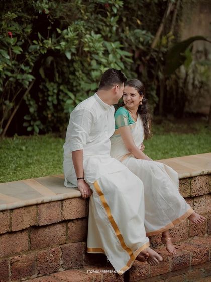 A quiet moment of conversation between the couple, seated by a temple pond.