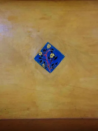 A close-up of a student-made tile, now installed in their school. This project was a powerful way to give them ownership and a lasting connection to their environment.