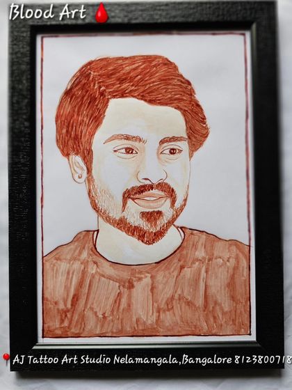 A handsome portrait of a young man, painted with his blood. The artwork is displayed in a simple black frame, making the reddish-brown tones of the portrait stand out.