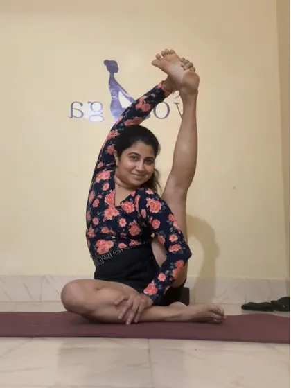 A smile through the stretch. Holding the Compass Pose, or Parivrtta Surya Yantrasana, which is a deep hamstring and shoulder opener. I believe in finding joy even in the most challenging asanas.