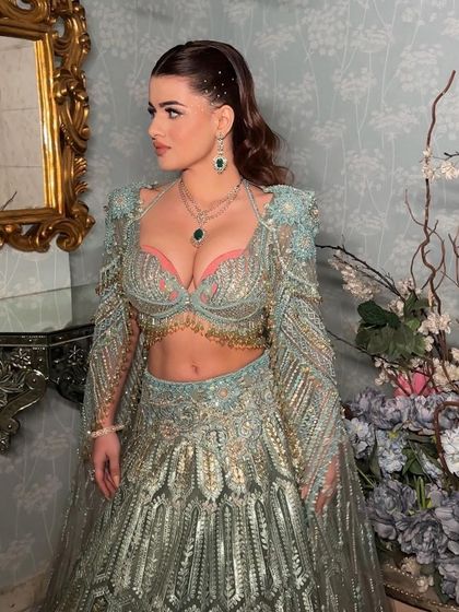 Another angle of the stunning rhinestone look. The hair is kept sleek and simple to let the makeup and outfit shine.