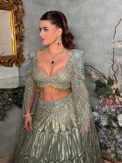 Another angle of the stunning rhinestone look. The hair is kept sleek and simple to let the makeup and outfit shine.