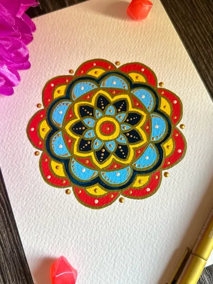 A small but mighty piece of art therapy. This mini mandala uses a classic primary color palette of red, yellow, and blue to create a bright and cheerful design that instantly lifts the spirits.