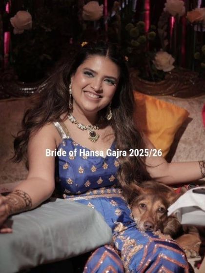 A beautiful portrait of the bride, cuddling with her dog during her mehendi. Her smile is radiant, and the moment is full of warmth and love.