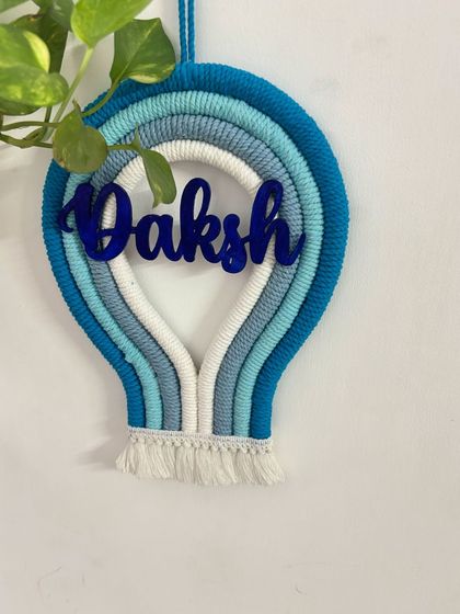 A clear, straight-on shot of the 'Daksh' parachute name hanging, perfect for seeing the full design and color combination.