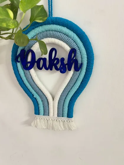 A clear, straight-on shot of the 'Daksh' parachute name hanging, perfect for seeing the full design and color combination.