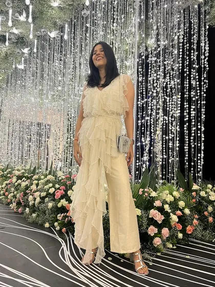A fun, ruffled jumpsuit against a sparkling backdrop. This is a great outfit for a sangeet or cocktail night where you want to be comfortable enough to dance.