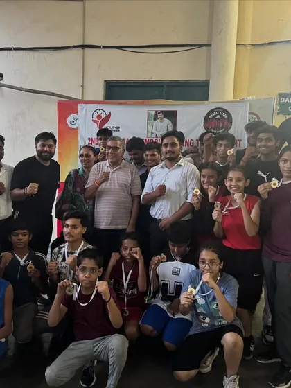 The entire team celebrating their victories at a boxing championship. Every medal is a win for the whole academy.