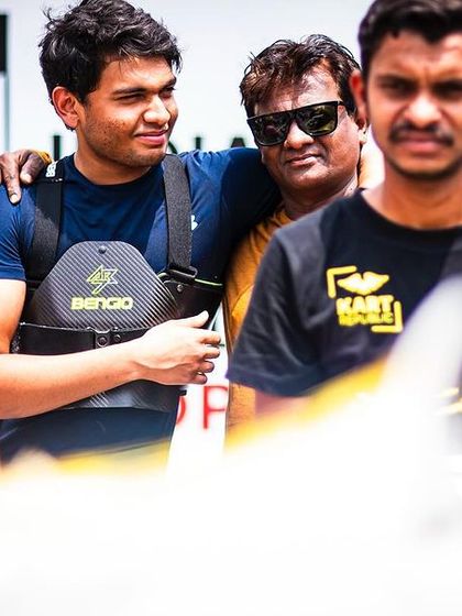 A candid moment of team camaraderie in the pits.