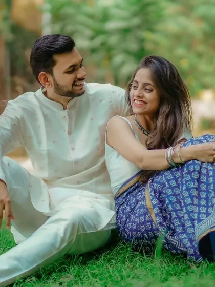 Sharing a happy moment together on the grass. This candid shot of Umesh and Janhavi in their traditional outfits is full of smiles and natural chemistry.