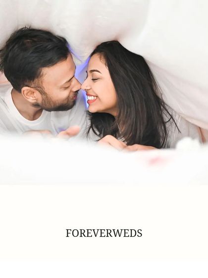 Cozy and intimate moments are just as important. Here, Akash and Priya share a sweet, smiling moment under a blanket, creating a feeling of warmth and closeness.