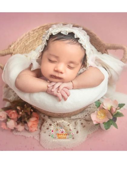 Another angle of this beautiful basket setup, showing the baby's hands gently folded. Every little detail is considered to create a perfect composition.