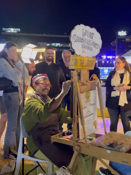 This is my happy place. Me, my easel, and a crowd of curious, smiling faces waiting to be turned into art. The energy of a live event is what fuels my creativity.