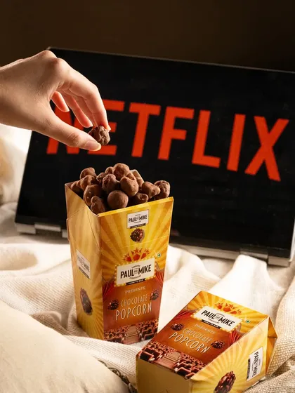 Chocolate popcorn from Paul & Mike, styled for a "Netflix and chill" theme. This tells a story about how to enjoy the product.