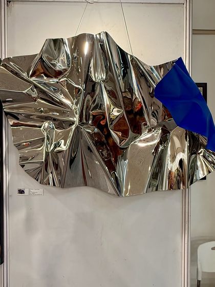 A full shot of the new Meteor sculpture on display, highlighting its impressive scale and reflective qualities.