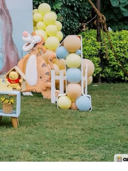 A Tigger prop next to a balloon-filled number '1', a perfect detail for a Winnie the Pooh first birthday party.