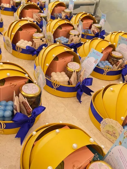 We handle orders of all sizes with care. Here's a look at a bulk order of our popular cradle announcement hampers, each one assembled and ready to spread joy.