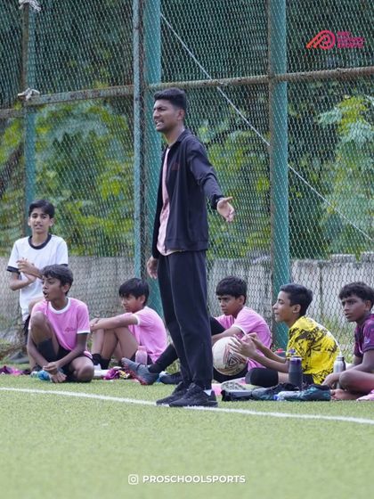 A coach instructs his players from the sidelines during a TYL match.