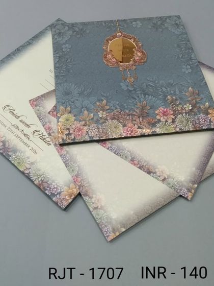 A beautiful invitation with a floral border in soft, muted colors. The design is elegant and understated, perfect for a sophisticated celebration.