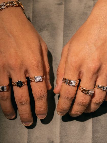 A full display of our men's rings, showing the variety of designs from simple bands to bold, diamond-studded pieces.