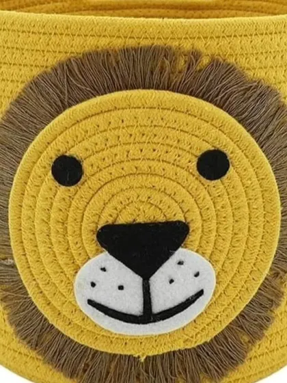 A close-up of the smaller lion-faced rope basket. The fringed mane adds a wonderful textural detail.