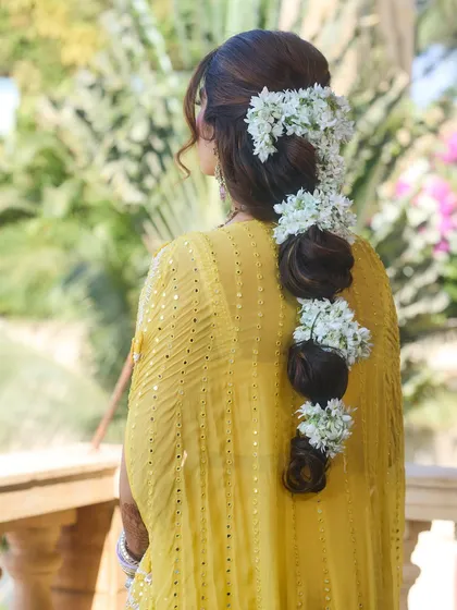 An example of our intricate hairstyling. This beautiful gajra braid, full of fresh mogra flowers, was the perfect complement to a sunny Haldi celebration.