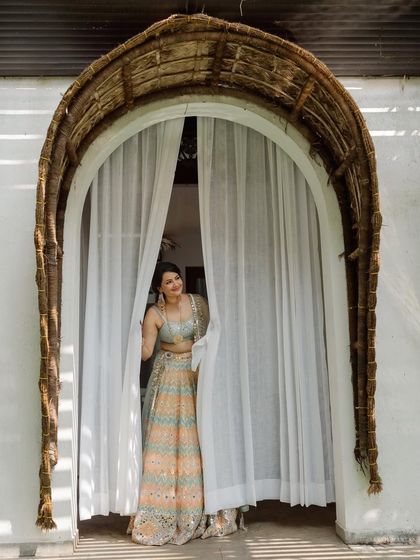 Peeking through the curtains. A playful and sweet shot that captures the bride's excitement and anticipation.