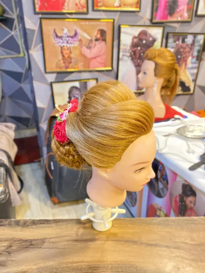 A side profile of the floral bun created by a student. This demonstrates their ability to create a balanced and elegant updo.